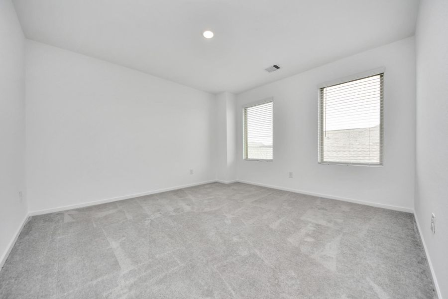 Flexible upstairs game room ideal for movie nights, a playroom, or a home office.