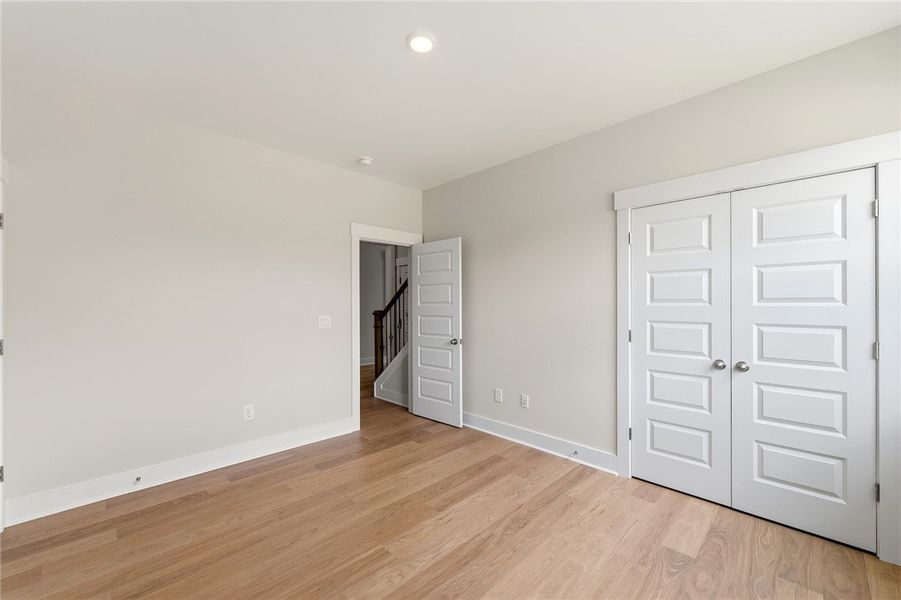 Blonde hardwood flooring and light-filled walls de