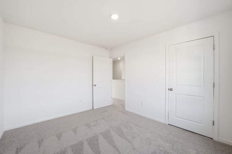A hallway with white doors. A hallway with white doors.