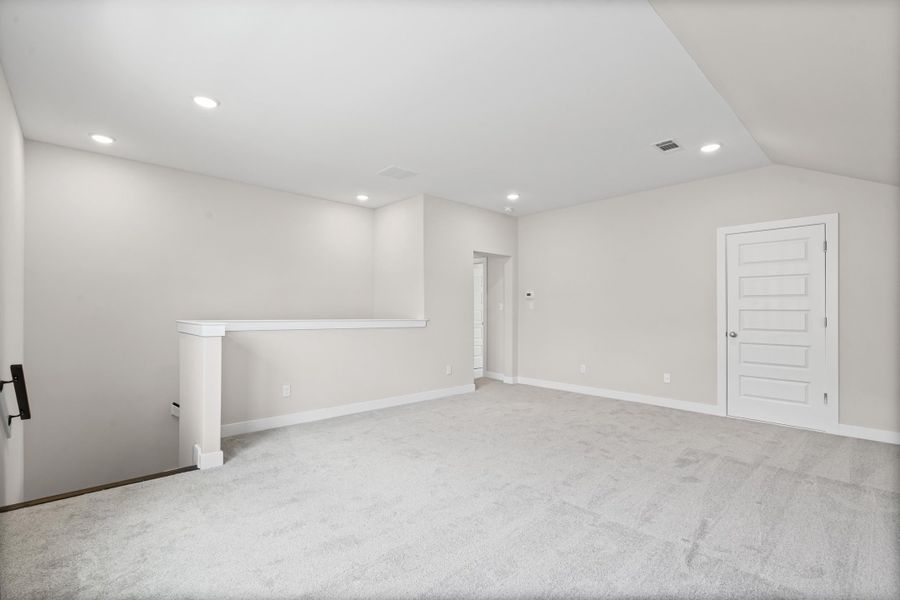 Spare room featuring carpet and recessed lighting