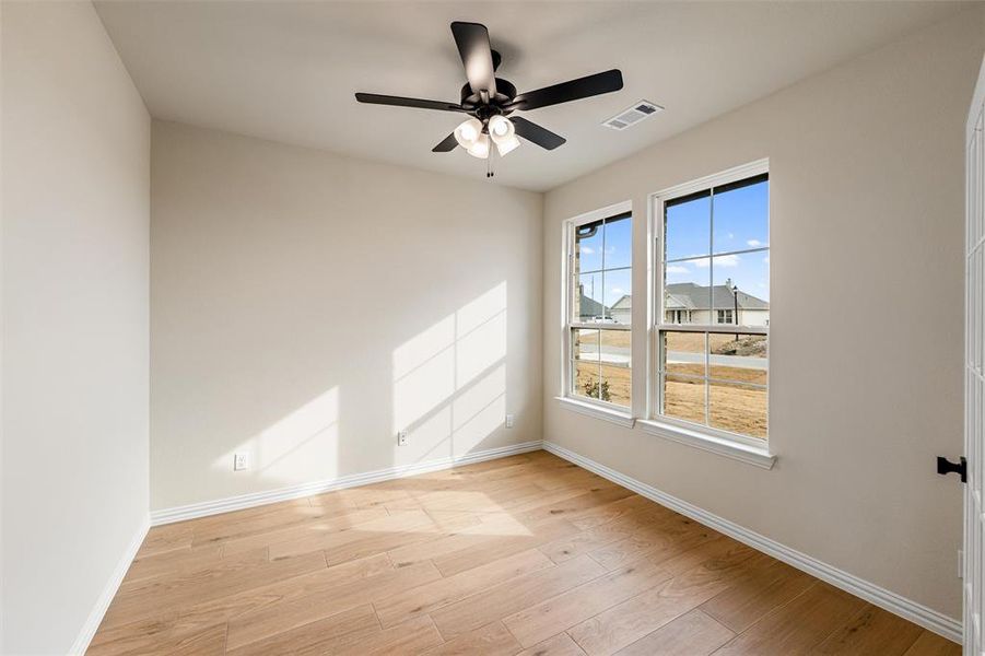 Spare room featuring light wood-type flooring and ceiling fan