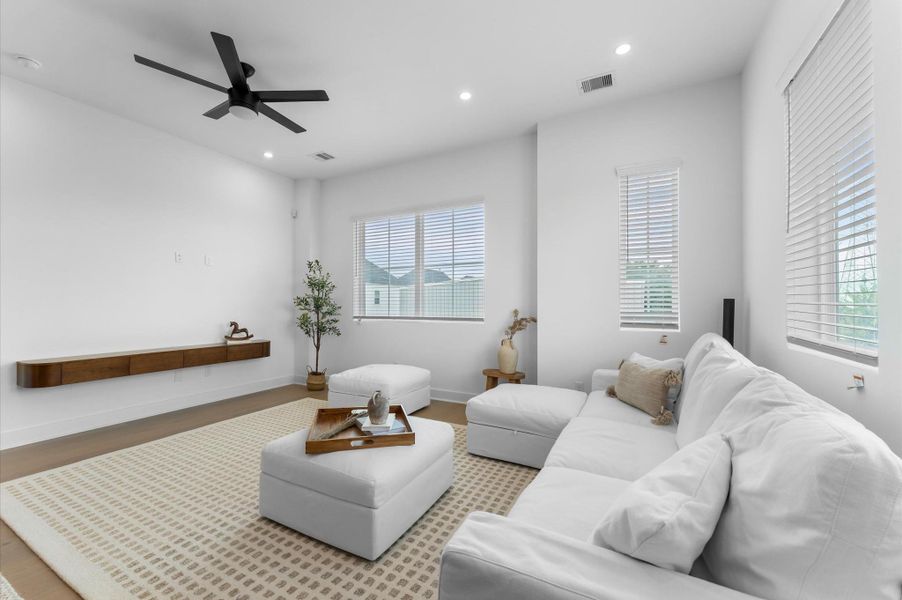 The second floor boasts a spacious open-concept living, dining, and kitchen area filled with natural light from abundant windows, featuring sleek modern finishes and warm engineered hardwood floors that create the perfect blend of style and comfort for everyday living and entertaining.