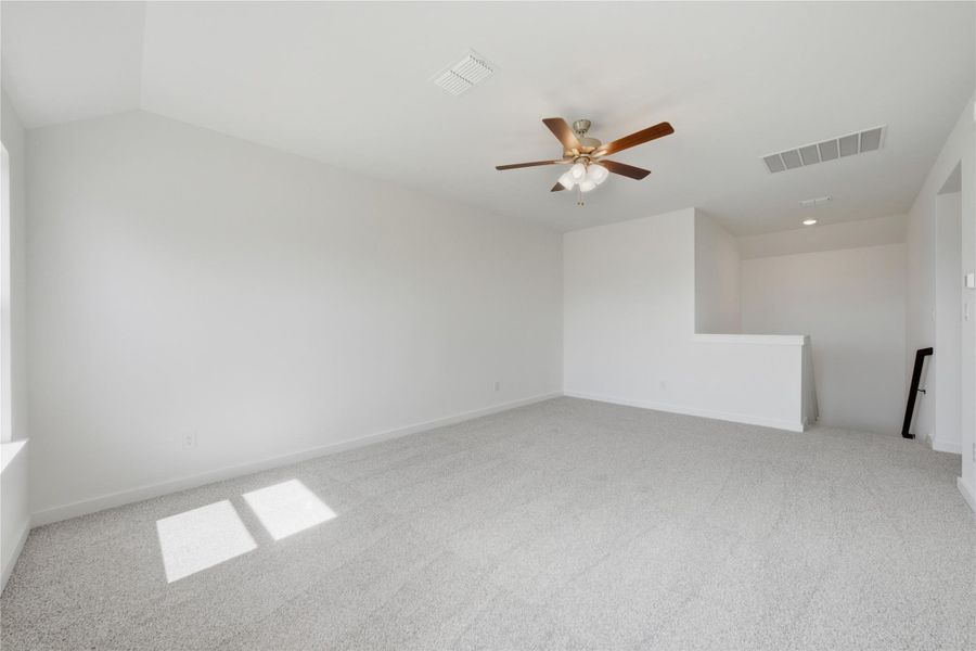 Empty room with light colored carpet and a ceiling fan Empty room with light colored carpet and a ceiling fan