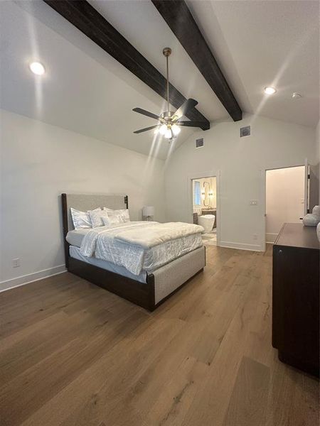 Vaulted ceiling featuring exposed wood beams and recessed lighting