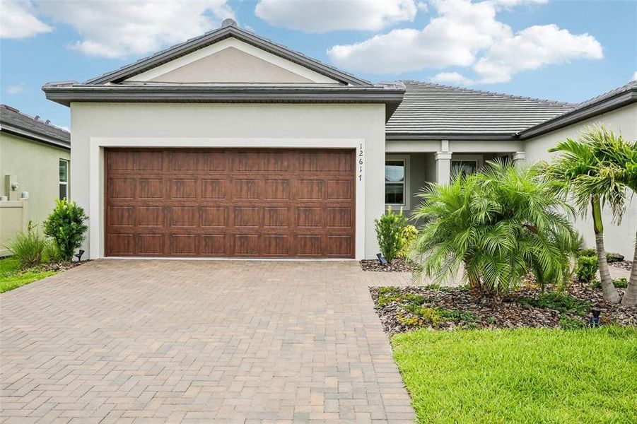 Front exterior of a new home in Prosperity Lakes Active Adult, Parrish, FL, highlighting curb appeal (Image 2).