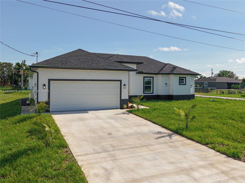 Front exterior of a new home in , Lehigh Acres, FL, highlighting curb appeal (Image 2).