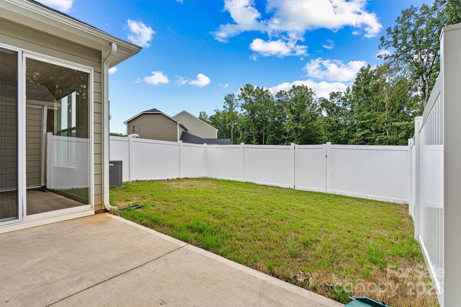 Step through the sliding doors on the main level and into your private backyard oasis—featuring a cozy patio area and lush green space, perfect for outdoor dining, play, or peaceful relaxation Step through the sliding doors on the main level and into your private backyard oasis—featuring a cozy patio area and lush green space, perfect for outdoor dining, play, or peaceful relaxation