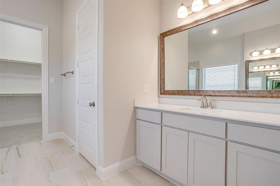 Bathroom featuring tile patterned floors and vanity