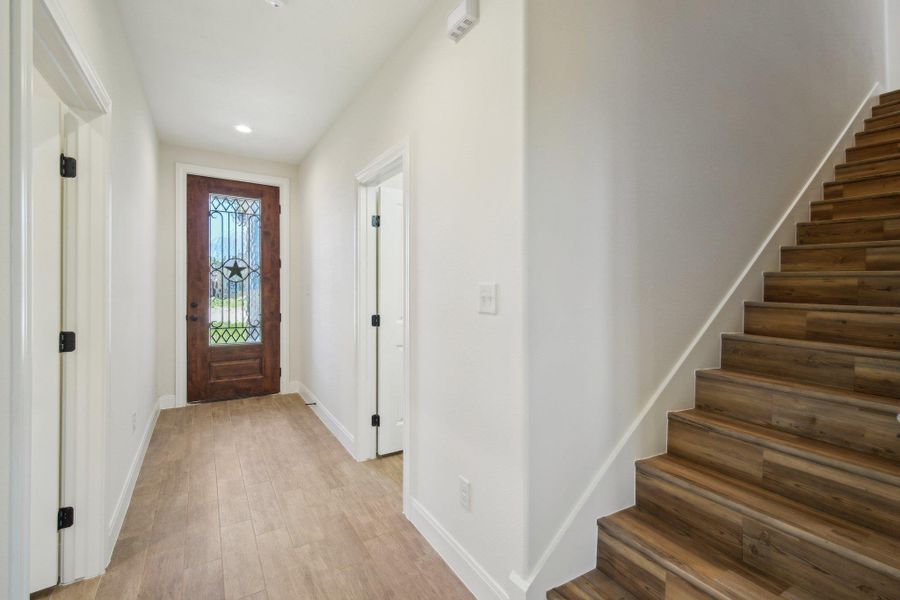 Foyer with baseboards, recessed lighting, stairway, and light wood-style floors Foyer with baseboards, recessed lighting, stairway, and light wood-style floors