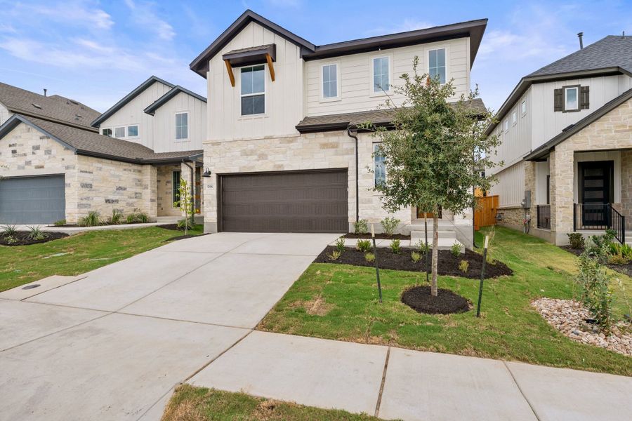 Front exterior of a new home in Heritage, Dripping Springs, TX, highlighting curb appeal (Image 2). Front exterior of a new home in Heritage, Dripping Springs, TX, highlighting curb appeal (Image 2).