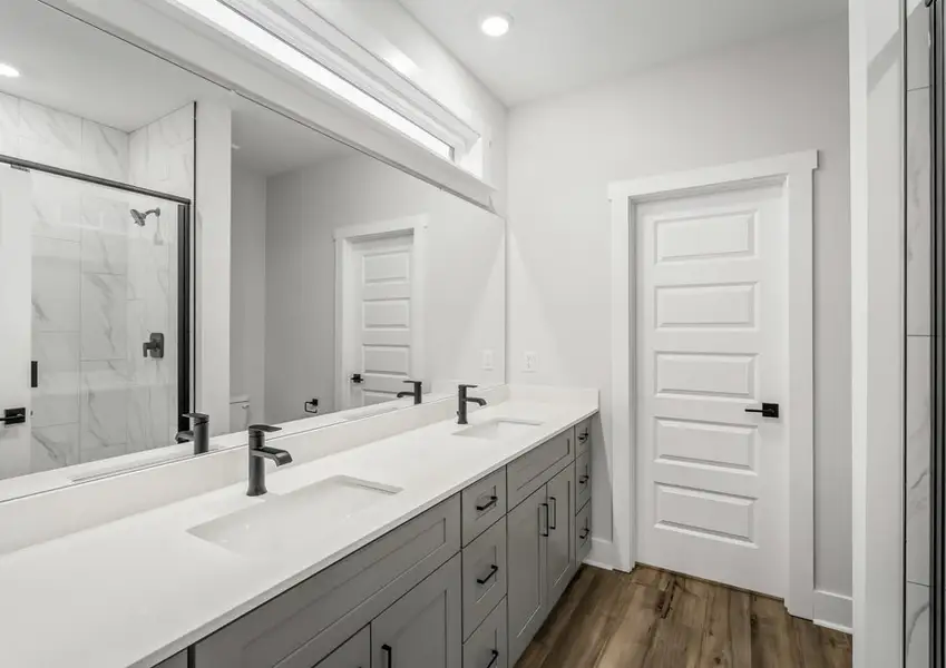 The master bath has a walk-in shower and a large vanity.