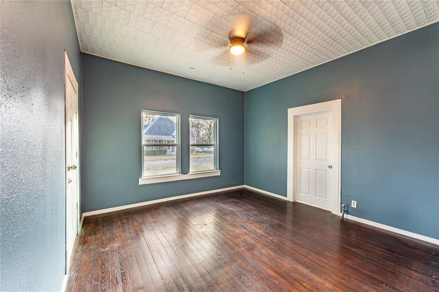 Empty room with dark hardwood / wood-style floors and ceiling fan Empty room with dark hardwood / wood-style floors and ceiling fan