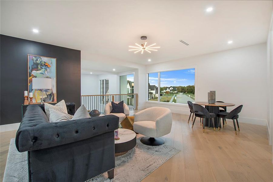 Living room with light hardwood / wood-style floors