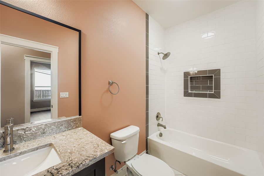 Full bath featuring bathing tub / shower combination, vanity, and a textured wall