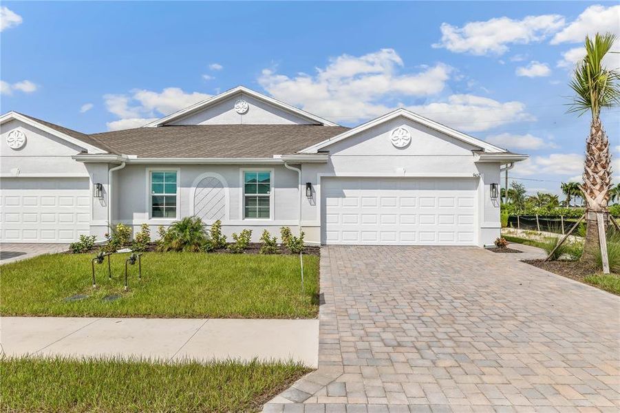 Front exterior of a new home in Sea Cove, Punta Gorda, FL, highlighting curb appeal (Image 2). Front exterior of a new home in Sea Cove, Punta Gorda, FL, highlighting curb appeal (Image 2).