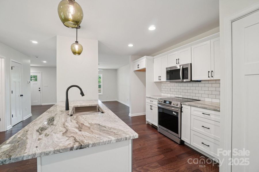 Local artisan made light fixtures over the large island