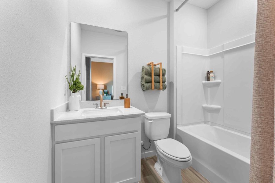 A bathroom with a tub sink and toilet. A bathroom with a tub sink and toilet.