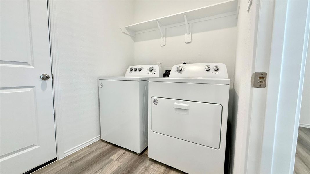 Utility room furnished with a BRAND NEW washer and dryer.