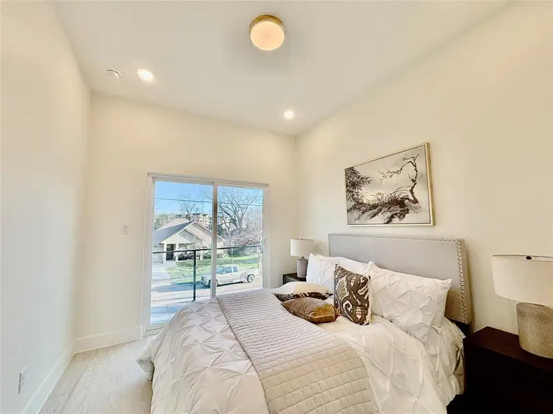 Bedroom featuring access to outside, wood finished floors, and recessed lighting