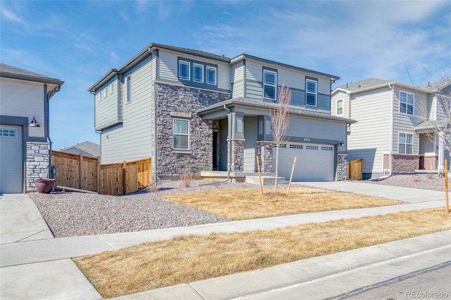 Front exterior of a new home in Buffalo Highlands: The Flora Collection, Commerce City, CO, highlighting curb appeal (Image 2).