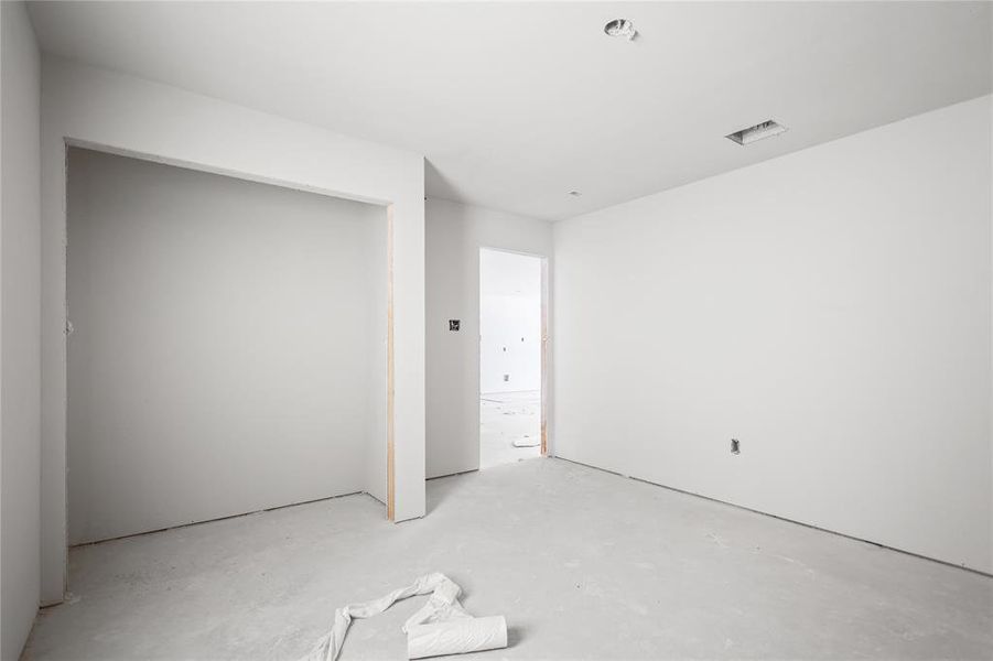 Room featuring light colored walls, a recessed light fixture, and an open doorway