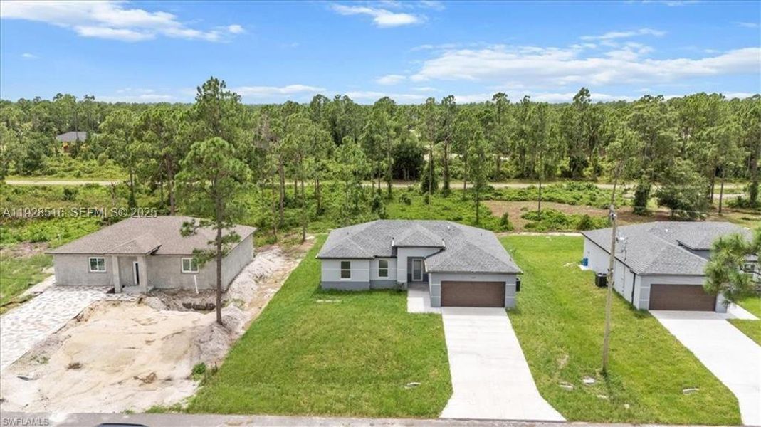 Front exterior of a new home in , Lehigh Acres, FL, highlighting curb appeal (Image 23).