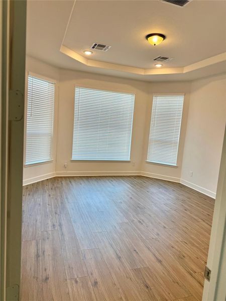 Primary bedroom with large bay area windows