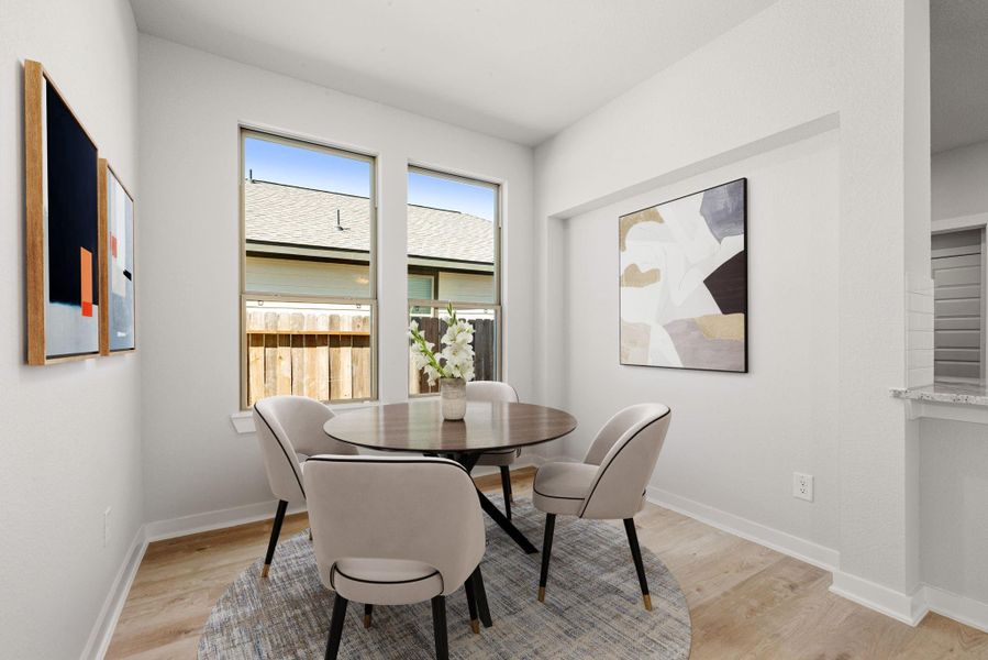This bright dining area is filled with natural light from large windows and features clean lines and neutral tones. Its open layout creates a comfortable, airy atmosphere ideal for everyday living. This bright dining area is filled with natural light from large windows and features clean lines and neutral tones. Its open layout creates a comfortable, airy atmosphere ideal for everyday living.