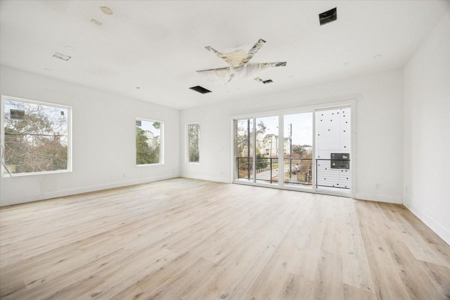 View of the living room, dining room and sliding glass doors leading to the balcony as of February 12, 2026