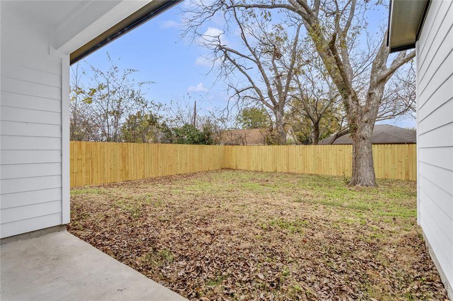 Fenced backyard featuring a patio