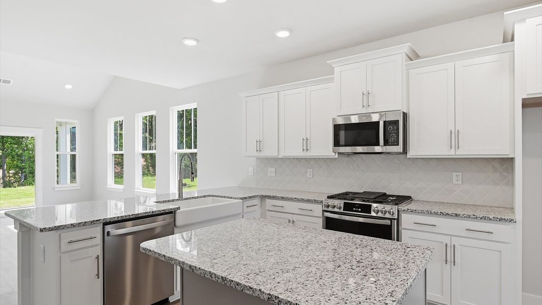 Exclusive kitchen design with a center island, granite countertops, and tasteful finishes throughout in Anderson, SC