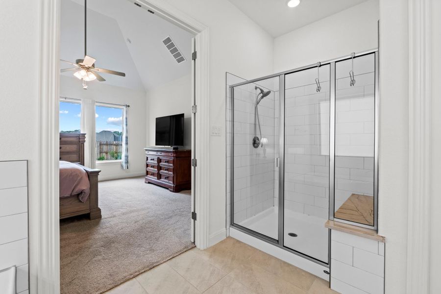 A modern shower enclosure with a built-in bench and subway tile completes this bathroom.
