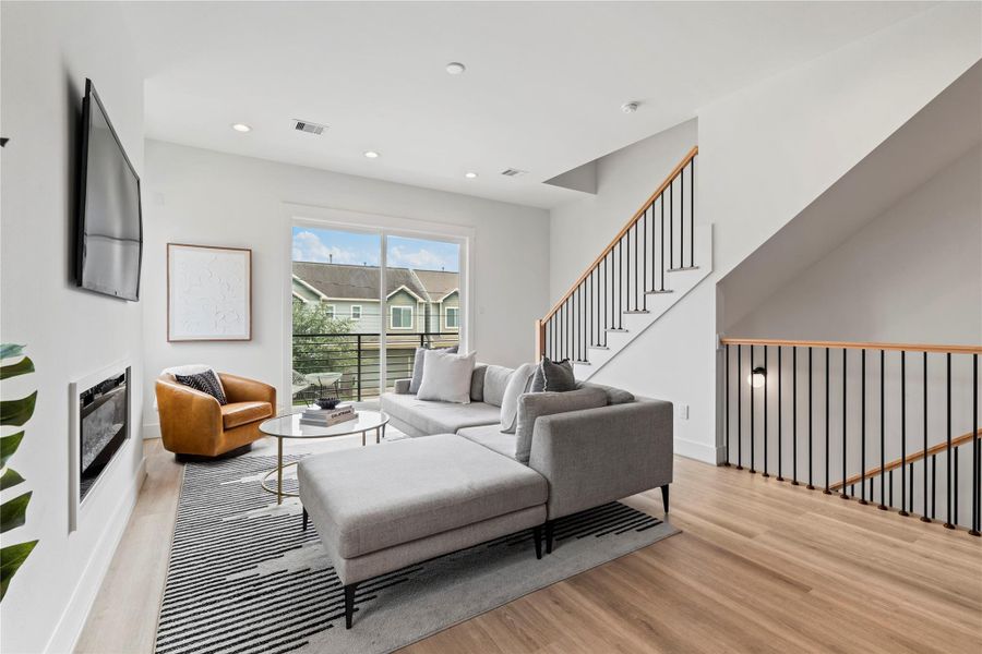 The open railing keeps the space feeling bright and airy, while large sliding doors lead to a covered balcony, perfect spot to fire up the Weber and unwind. The open railing keeps the space feeling bright and airy, while large sliding doors lead to a covered balcony, perfect spot to fire up the Weber and unwind.