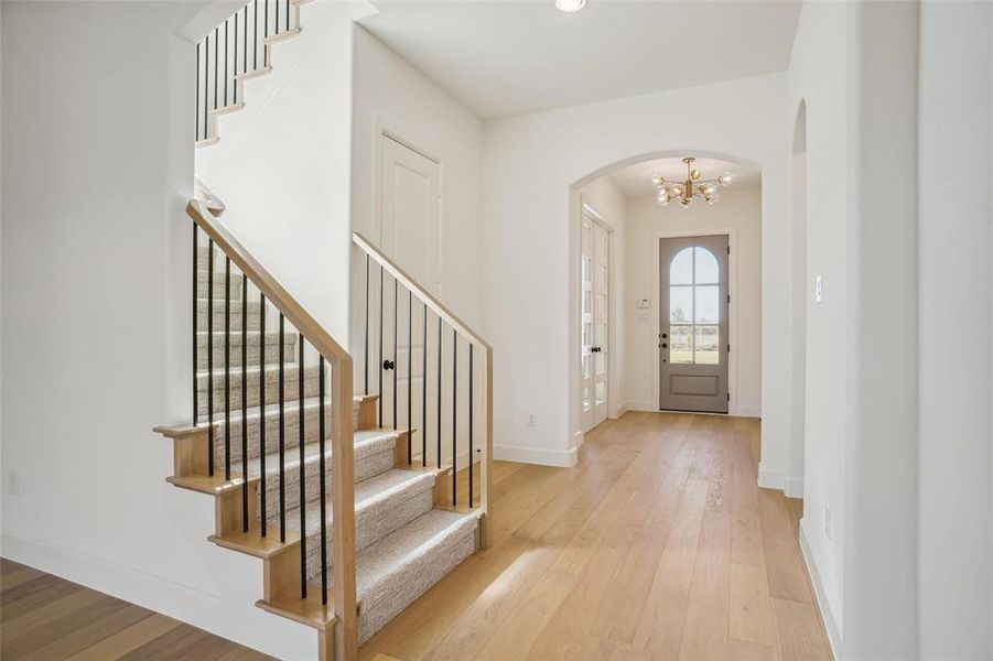 Foyer with a chandelier and light hardwood / wood-style flooring