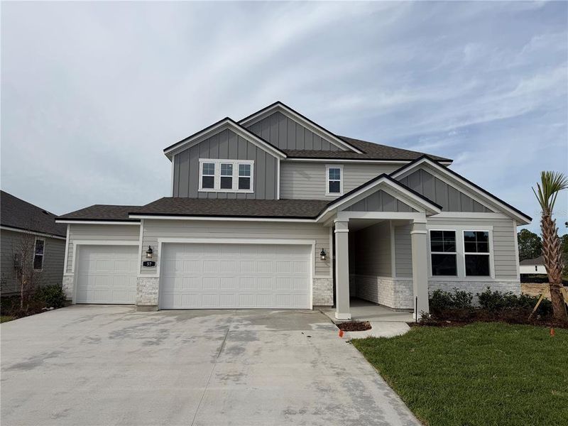 Front exterior of a new home in The Cypress Series at Reserve East, Flagler Beach, FL, highlighting curb appeal (Image 22).