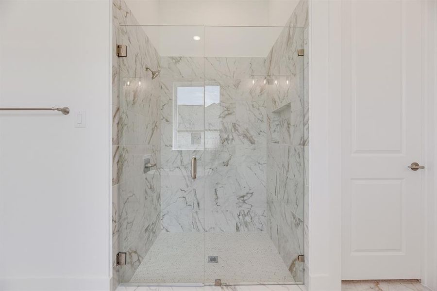 Bathroom with a marble finish shower