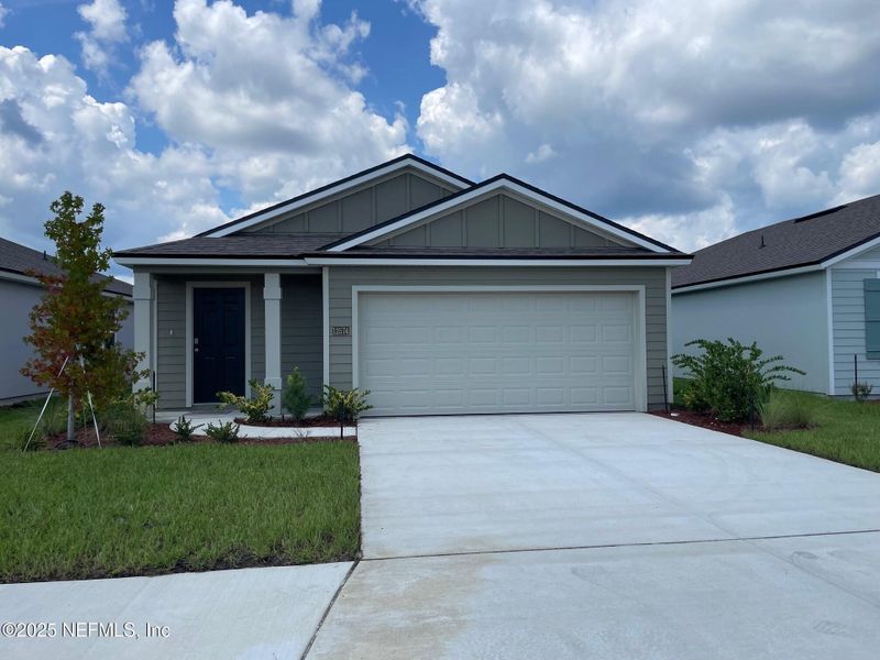 Front exterior of a new home in The Arbors, Jacksonville, FL, highlighting curb appeal (Image 22). Front exterior of a new home in The Arbors, Jacksonville, FL, highlighting curb appeal (Image 22).