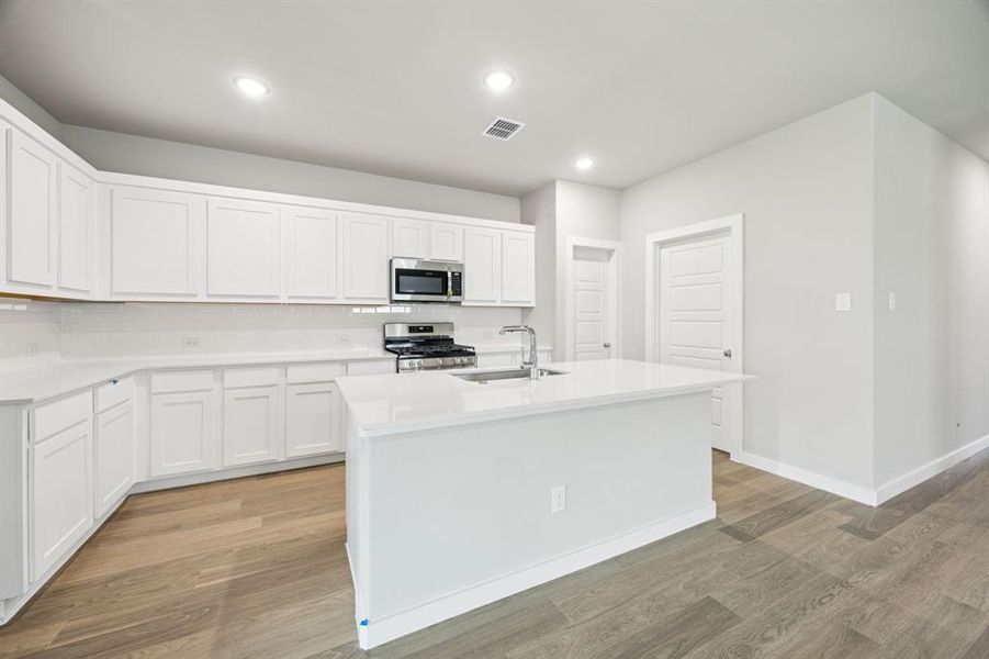 Kitchen in the Hayden home plan by Trophy Signature Homes – REPRESENTATIVE PHOTO