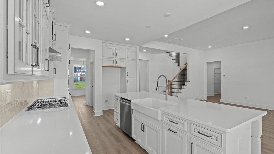 Vibrant kitchen layout with a center island, refined finishes, and open-concept flow