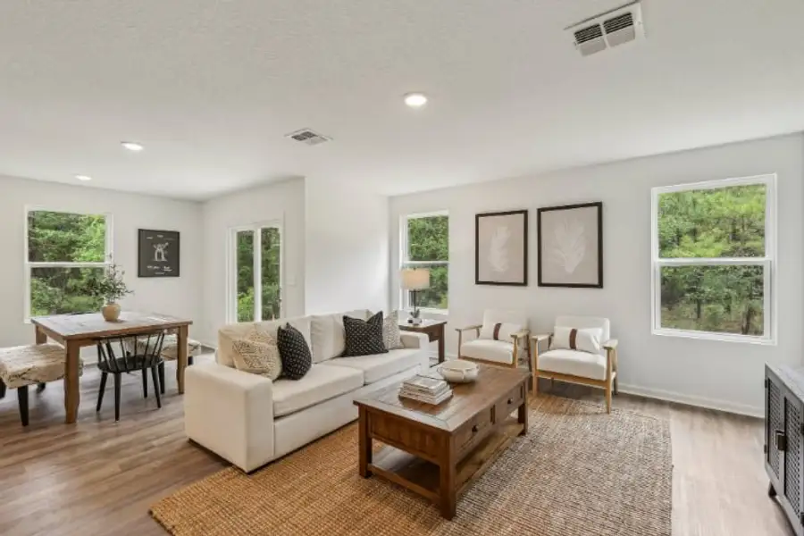 A living room with a white couch and a table.