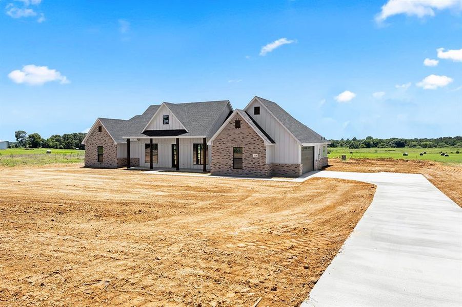 Front exterior of a new home in , Cleburne, TX, highlighting curb appeal (Image 18). Front exterior of a new home in , Cleburne, TX, highlighting curb appeal (Image 18).