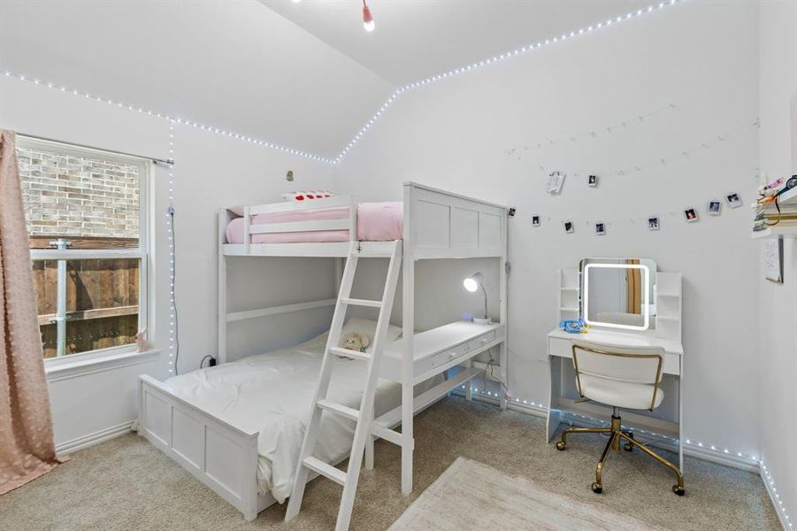 Bright bedroom featuring neutral-toned carpet flooring and a single window with white trim