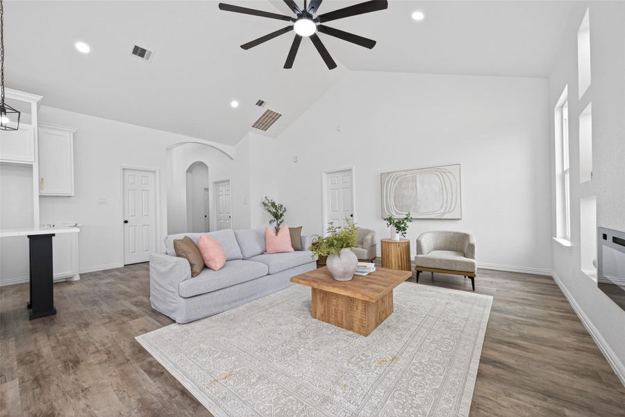 Seamless open-concept design connecting the living room, kitchen, and dining areas.