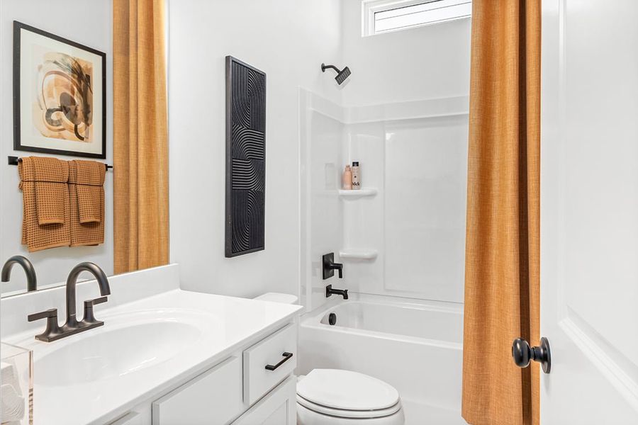 A bathroom with a tub sink and toilet.