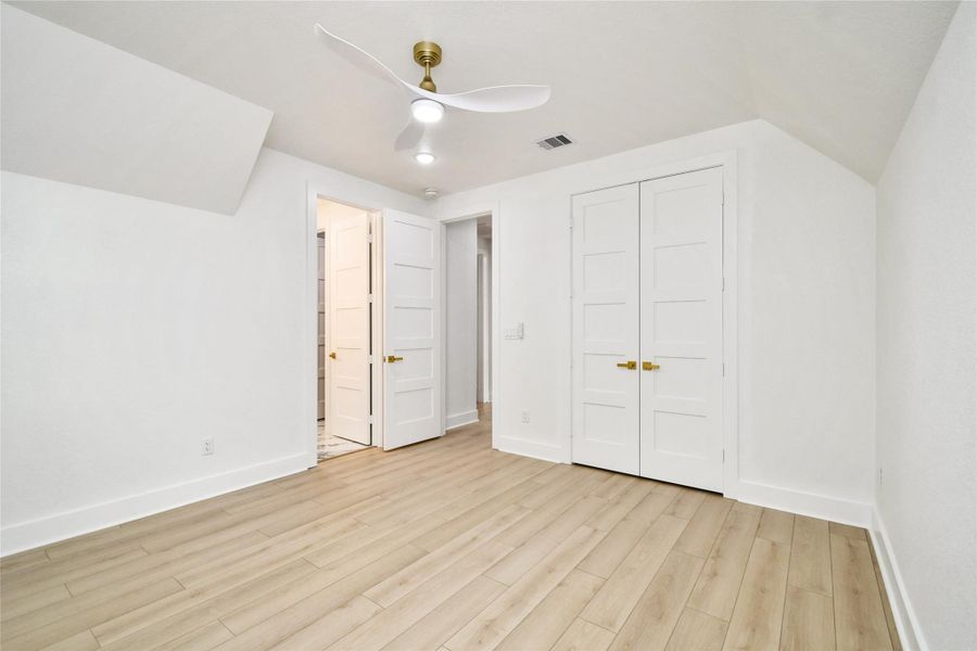 Generously sized secondary bedroom featuring clean lines, ample closet space with stylish shaker-style doors, and recessed lighting. The thoughtful layout provides easy access to the well-appointed bath.