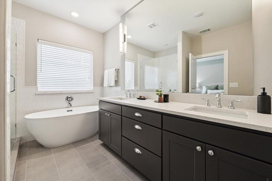 Indulge in the luxury of a spa-like retreat in the beautifully designed primary en-suite bath. Thoughtfully crafted for both relaxation and functionality, this serene space features dual vanities, providing ample storage and convenience.