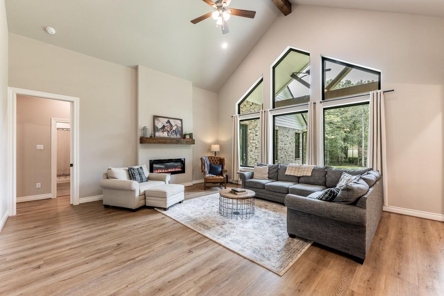 Inviting Living Room with beamed cathedral ceiling and electric fireplace