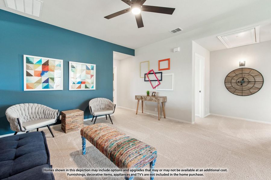 Living room with teal accent wall, ceiling fan, carpet flooring, and colorful wall decor