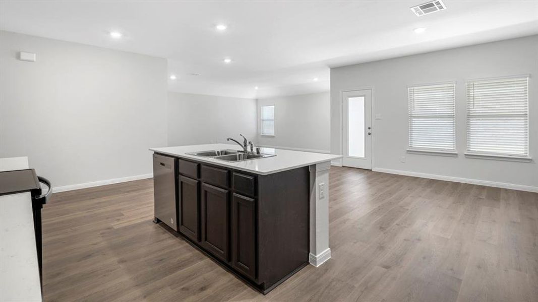 Kitchen featuring a kitchen island with sink, stove, stainless steel dishwasher, recessed lighting, and open floor plan