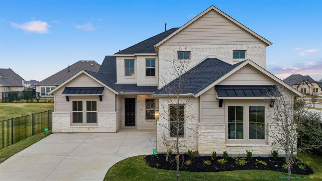 View of front of property featuring a standing seam roof, stone siding, and a metal roof View of front of property featuring a standing seam roof, stone siding, and a metal roof